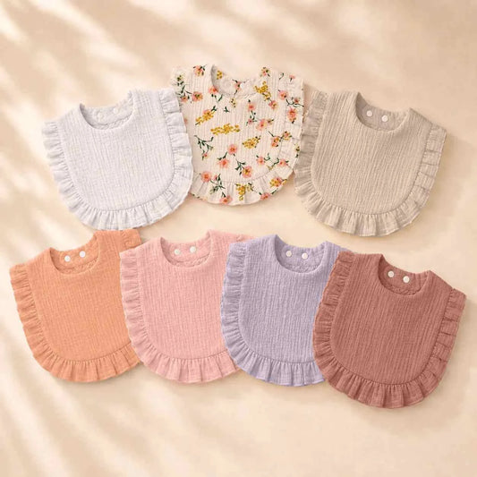 Baby Lace Bibs Set of 7 in soft gauze, with ruffled edges in muted pink, lilac, beige, and floral print.