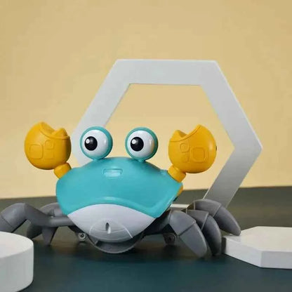 Auto-Sensing Obstacle-Crawling Crab Toy with a turquoise plastic body, gray segmented legs, yellow claws, and large googly eyes.