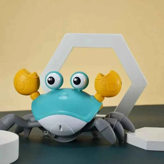 Auto-Sensing Obstacle-Crawling Crab Toy with a turquoise plastic body, gray segmented legs, yellow claws, and large googly eyes.